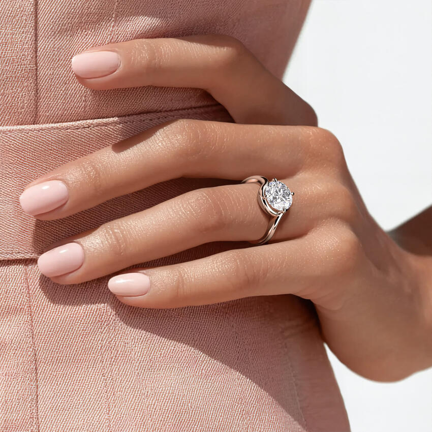 Ring setting worn on the hand in white gold, shown with a round center stone