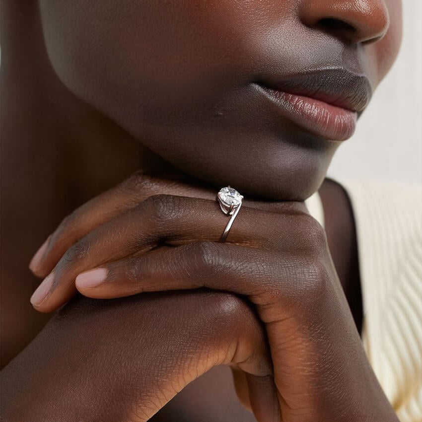 Ring setting worn on the hand in white gold, shown with an oval center stone